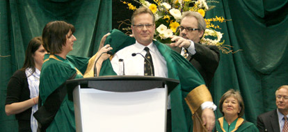 Durham Colleges new president Don Lovisa accepting ceremonial robe
