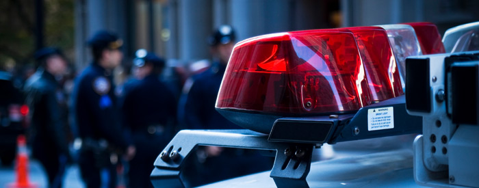 Police car lights with police in the background