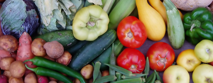 Various vegetables laying on a wood surface