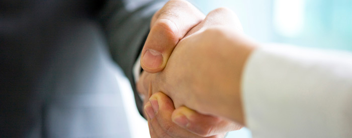 A business man and woman shaking hands