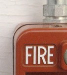 A red fire alarm on a wall