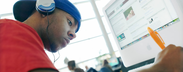 A student using an iMac in a computer lab