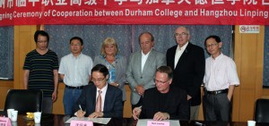 New-and-Notable-China-MOU President Don Lovisa signs an MOU
